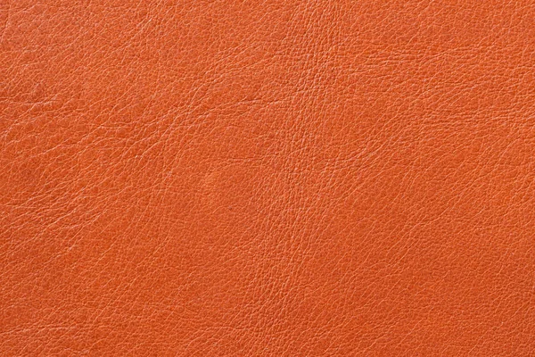 Textura de cuero genuino de cerca, piel de vaca, naranja. Para fondos naturales, artesanales, telón de fondo, uso de composición de sustrato — Foto de Stock