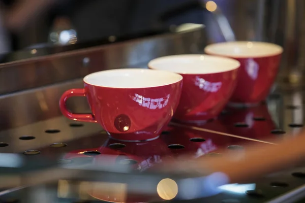 Rote Tassen auf dem Stand, Kaffeemaschine, Bar. Vintage dunklen Ton, Kaffeezeit, für Hintergrund. Kaffeekultur und professionelle Kaffeemaschine, Service, Catering-Konzepte — Stockfoto
