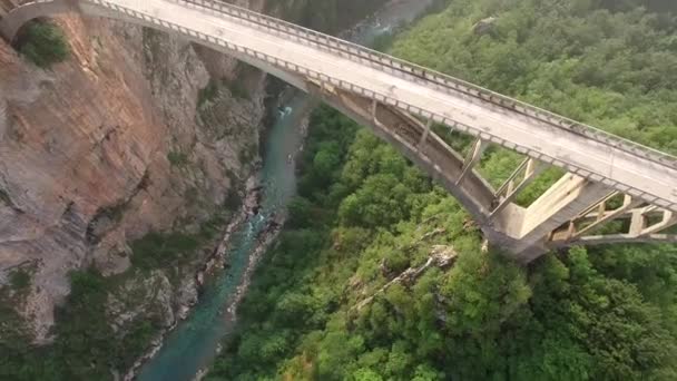 Car on the road from above. Tara river green canyon. Best of Montenegro beautiful nature Europe sightseeings. Concrete arch historical bridge. 