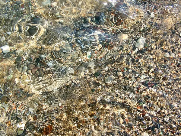 Kieselsteine am Strand im Wasser — Stockfoto