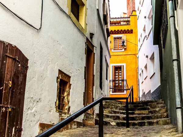 An old crooked street in the seaside town of Lloret de Mar in the province of Girona in the autonomous community of Catalonia in Spain