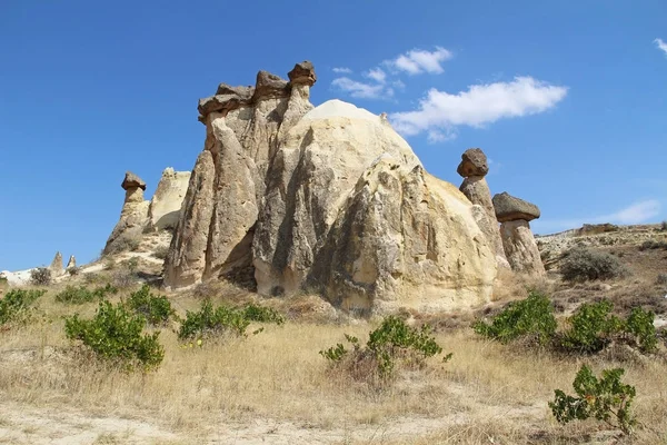 Rocks looking like mushrooms dramatically lit by a sun in Chavushin in Cappadocia, Turkey. — Stock Photo, Image