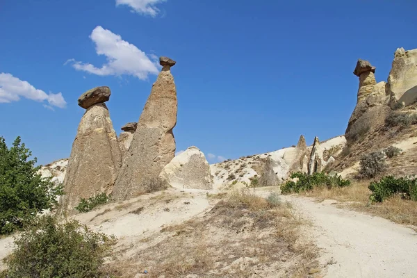 Rocks looking like mushrooms dramatically lit by a sun in Chavushin in Cappadocia, Turkey. — Stock Photo, Image