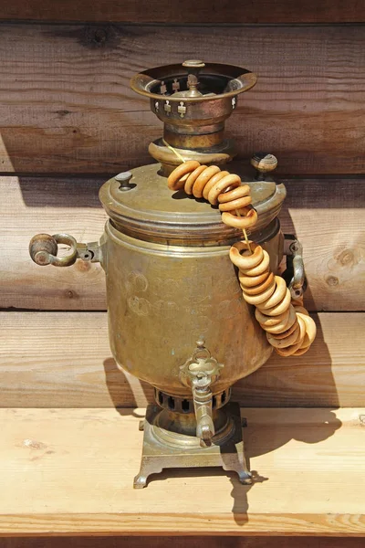 Russian samovar with a bunch of bagels on it. The Russian teapot.