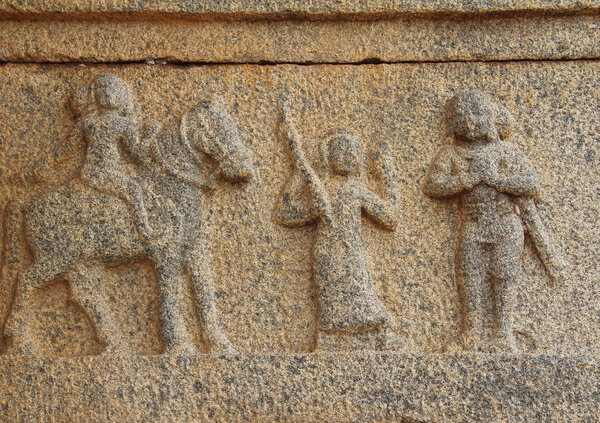 Hampi, Karnataka, India - October 20, 2017: Stone bas-reliefs on the walls around the Vittala Temple.