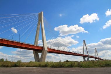Summer landscape with a view of the cable-stayed bridge on the river Oka, Murom, Russia. clipart