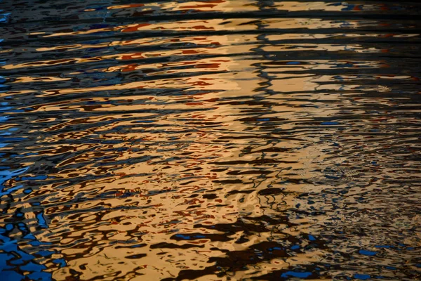 Golden rippled water surface — 图库照片