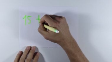 Genç öğrenci toplama ve çıkarma gibi basit matematiksel işlemleri hesaplar. Tekrarlama bilgeliğin anasıdır. Öğrenci ödevini matematik üzerine çalışıyor. İnsan çarpım tablosunu tekrarlar