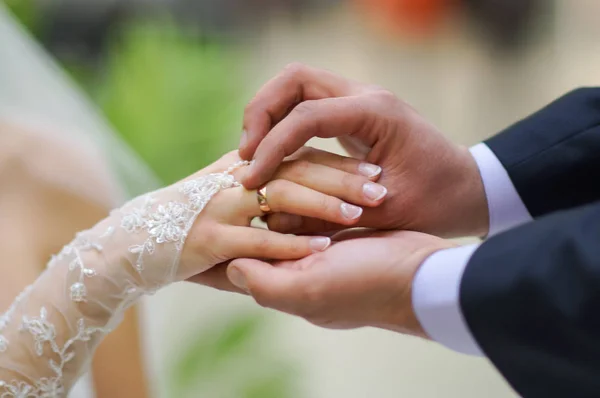 Groom wears ring on bride's finger — Stock Photo, Image