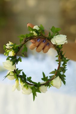 bir el gerçek çiçek çelenk tutar. Düğün dekorasyon, iç. Şenlikli .