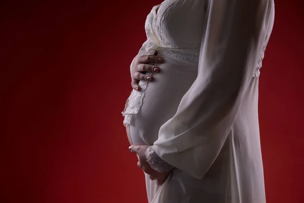 Young pregnant woman in anticipation of a child. studio photos on a background. concept of happy motherhood Royalty Free Stock Photos