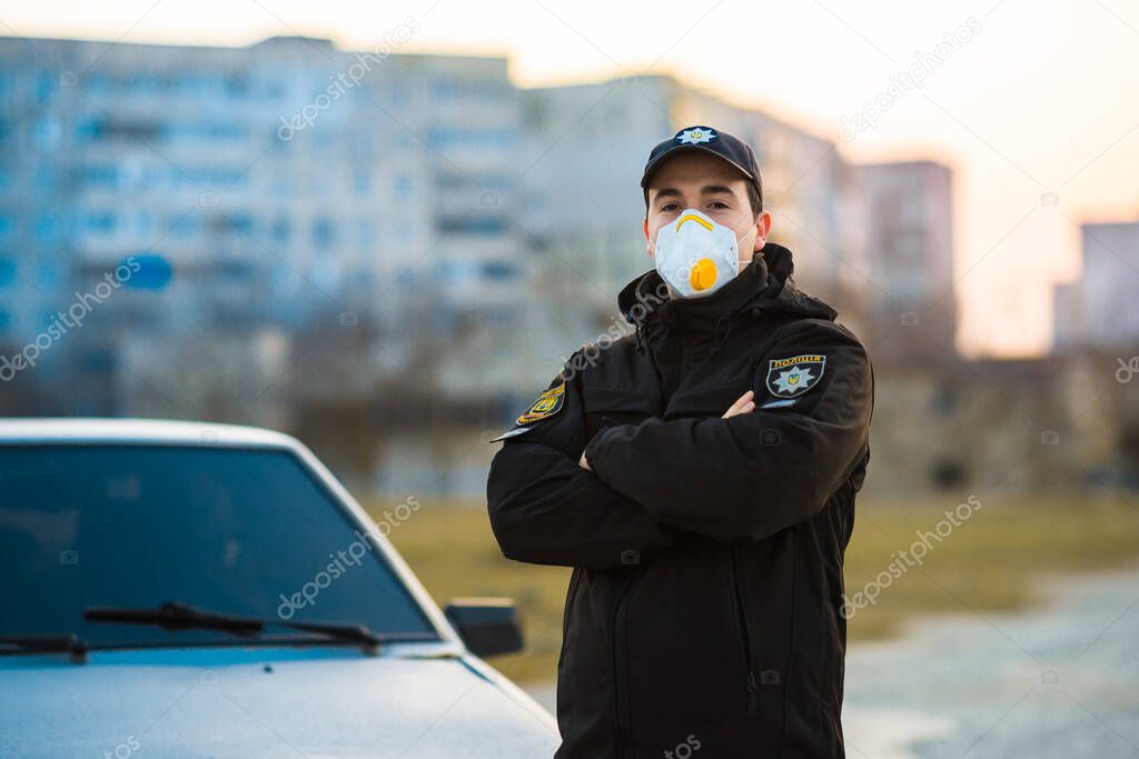 medium sharp. policeman in a protective mask against the background of the city. the fight against the virus. emergency. pandemic. Ukraine. coronavirus