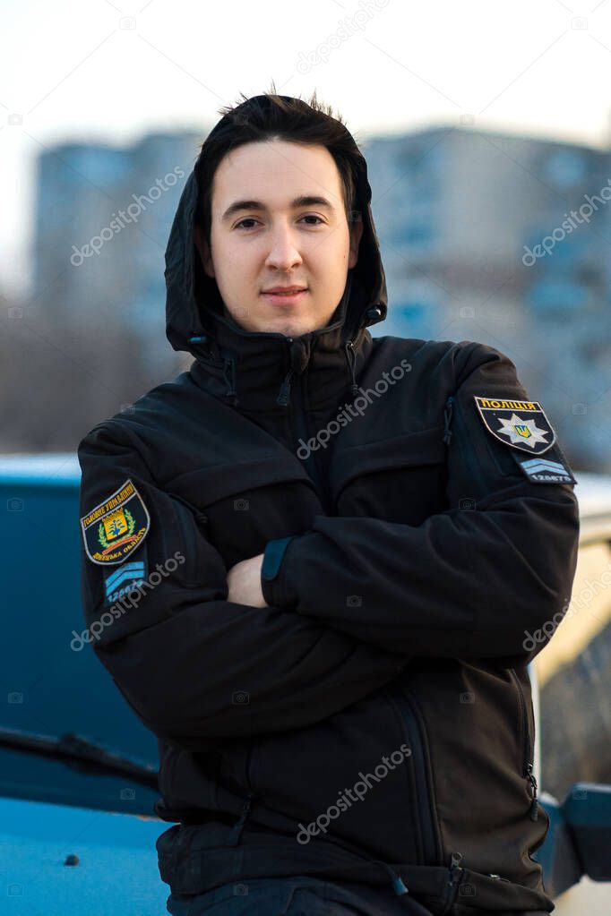medium sharp. A policeman in uniform against the background of the evening city. balance of guard. Ukraina. Mariupol