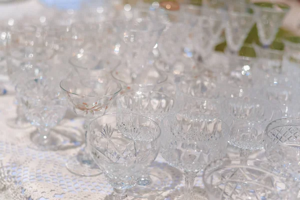 White table and row of beautiful glasses, celebration design set background