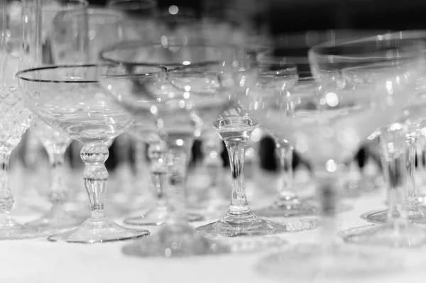 White table and row of beautiful glasses, celebration design set background