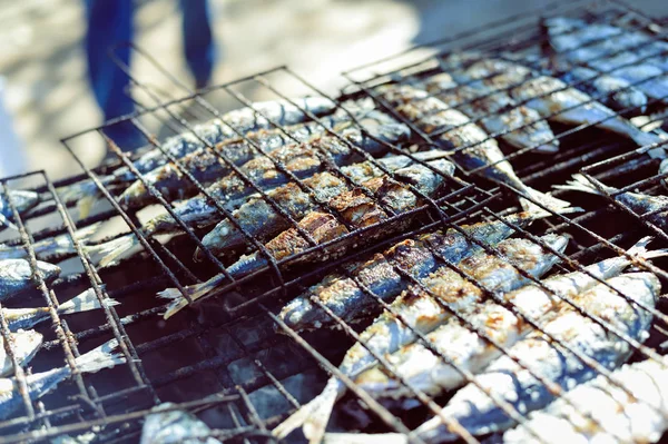 Top view on grilling fish on barbecue, background outdoors — Stock Photo, Image