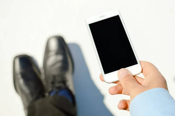 Business man hand holding using mobile smart phone on light background. Closeup view of mock up display network connection — Stock Photo, Image