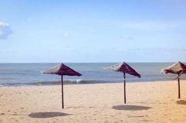 Beach Umbrella - tropical holiday tranquility background. Sunny outdoors seascape
