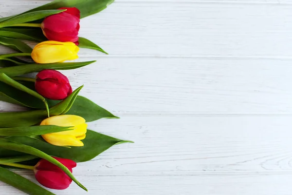 Wooden background with fresh tulips. Conception holiday, March 8