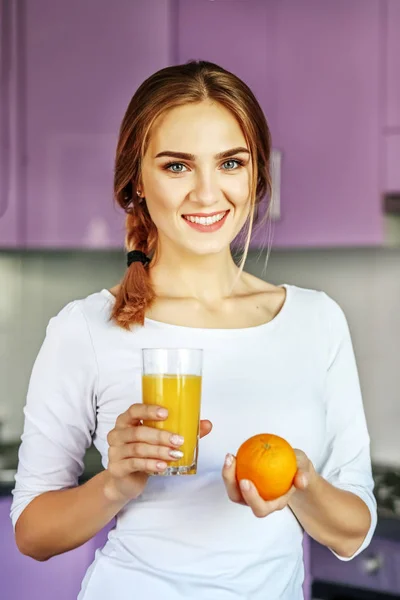 Mosolygós kislány ivás narancslé a reggeli. A konc — Stock Fotó