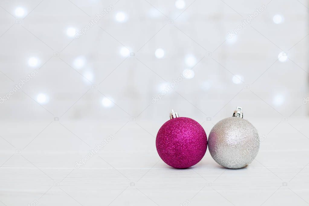 White background with pink balls. The concept of Christmas and N