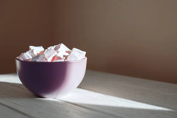 Marshmellow un tazón de madera púrpura sobre un fondo blanco. Vista superior — Foto de Stock