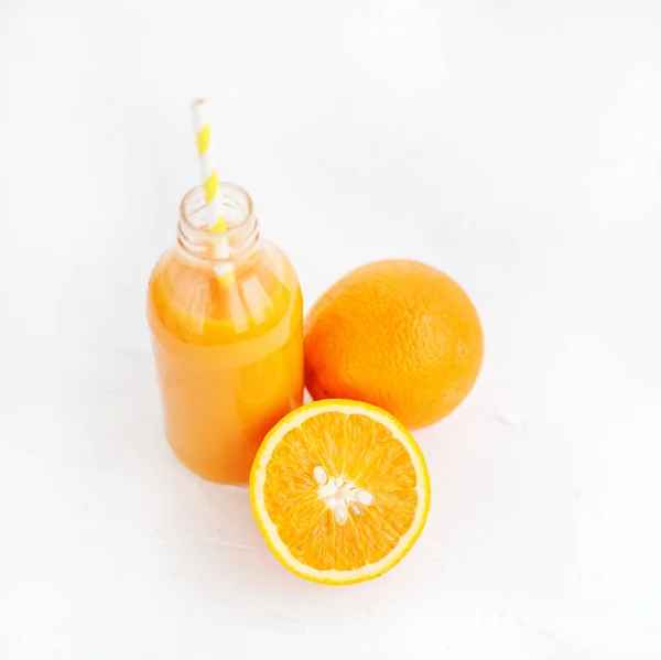 Apelsinjuice i en flaska. Vit bakgrund. — Stockfoto