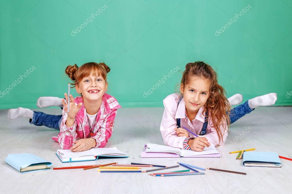 Two fun little children do homework. The concept of childhood