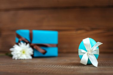 Yumurta ve hediye ahşap arka plan üzerinde. Yazıt için bir yer. Konsantrasyon