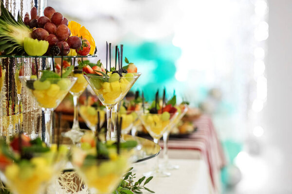 Mix of fruits on the festive table. The concept of food, catering, restaurant and party celebration.