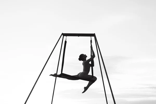 Beautiful girl practicing fly-yoga poses — Stock Photo, Image