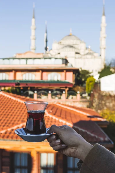 Woman holding cup of traditional Turkish tea — Stock Photo, Image