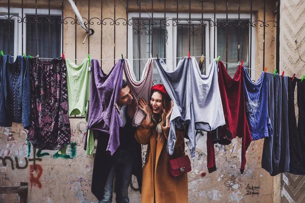 Couple having fun in drying laundry — Stock Photo, Image