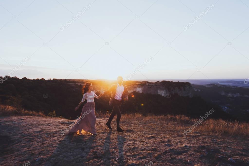 Silhouette of loving couple in rays of sun