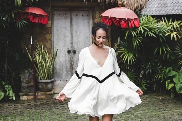 Young woman in white tunic