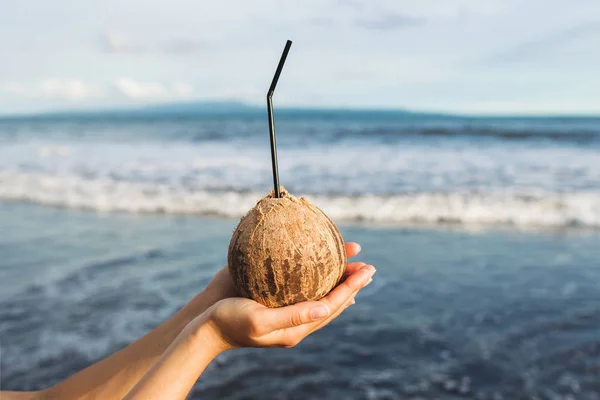 stock image Woman's hand holding coconut