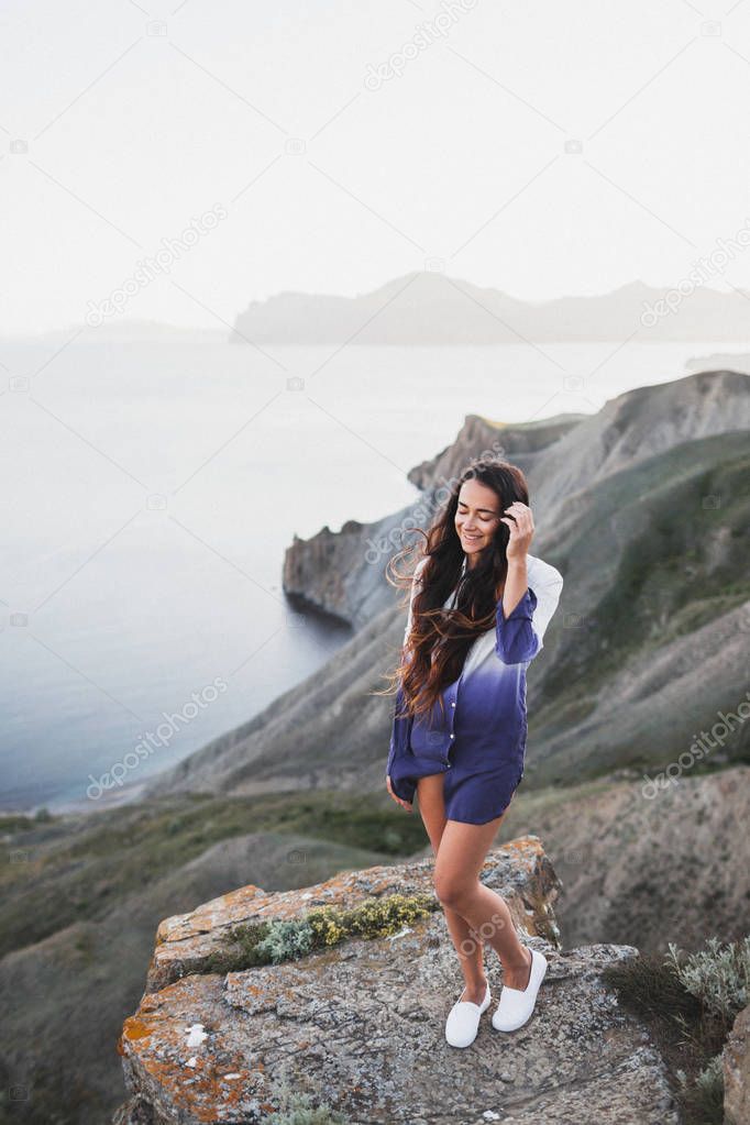 Woman standing on a sea cliff 