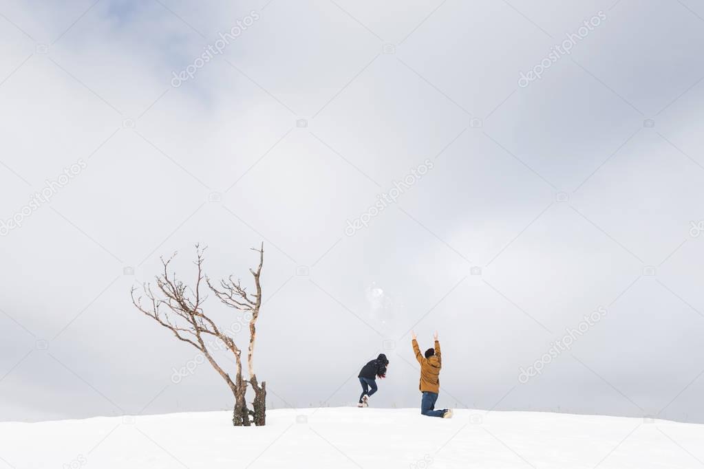 Tourists couple having fun in snow 