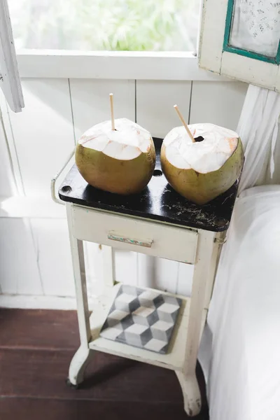 Coconuts on vintage table — Stock Photo, Image