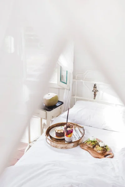 Breakfast in bed on wooden tray — Stock Photo, Image