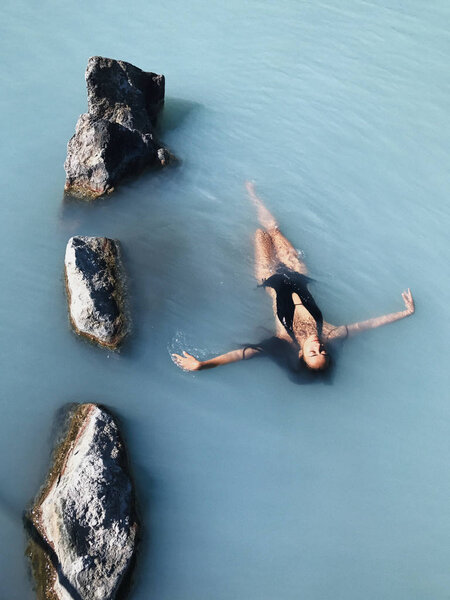 Girl relaxing in Blue Lagoon Stock Photo