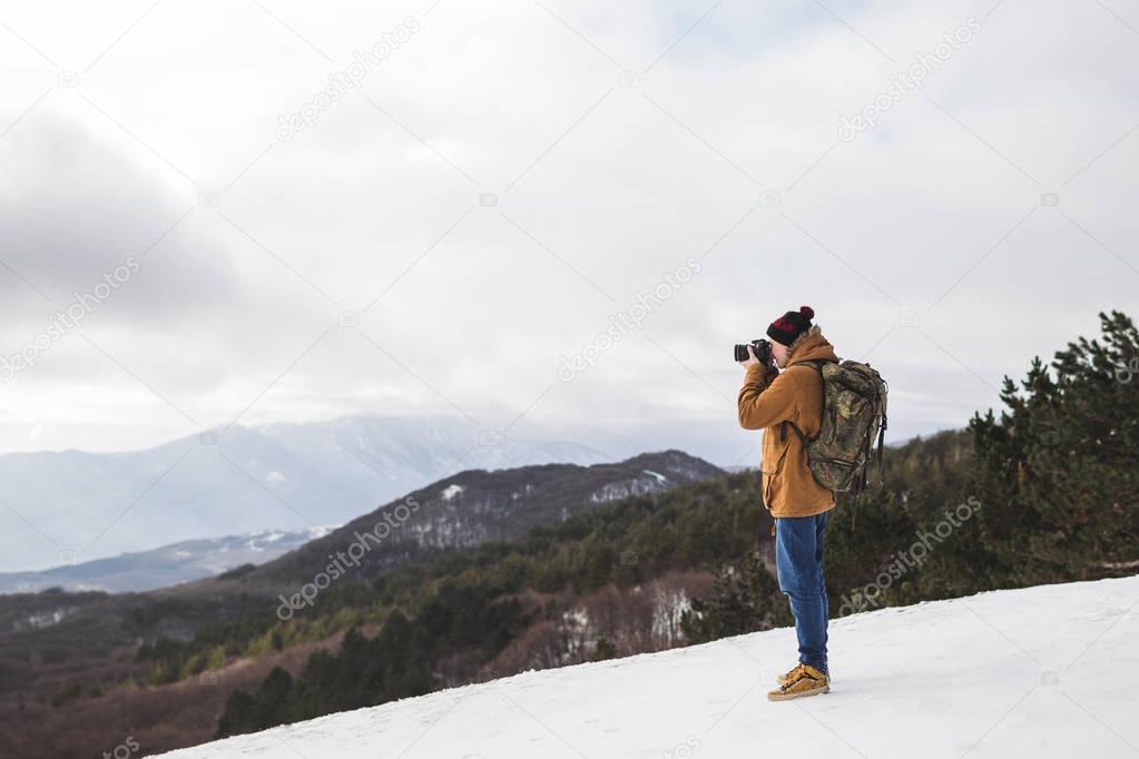 Tourist taking photo of mountains