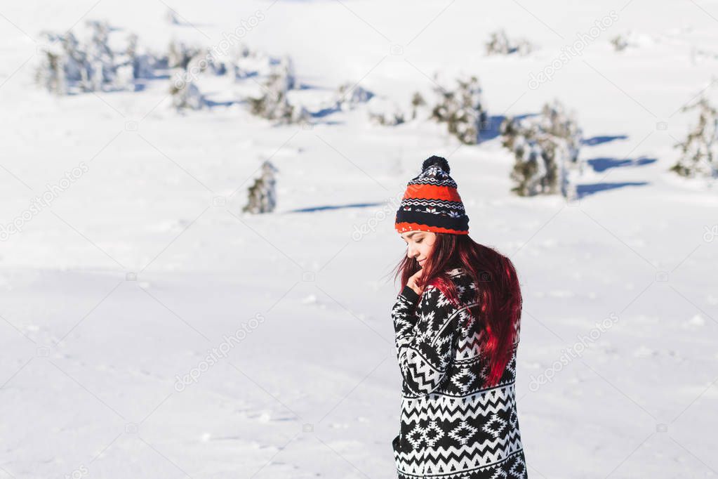 Woman with red hair in cardigan