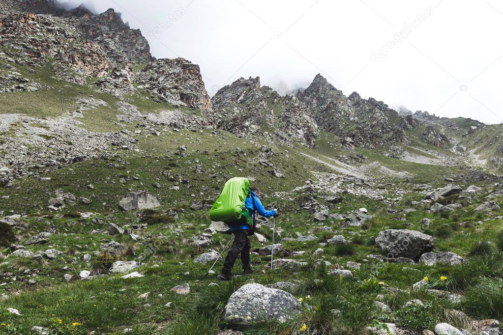 Tourist with large backpack hiking