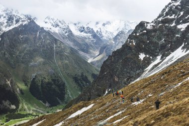 Group of tourists hiking in Elbrus region clipart