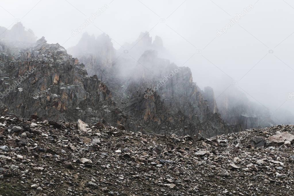 alpine landscape with rocks and fog