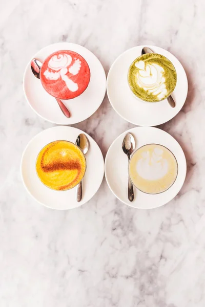 Quatro café latte colorido diferente — Fotografia de Stock