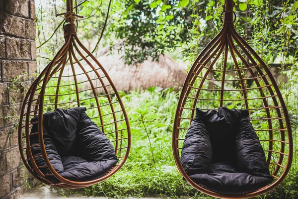 Two Rattan Hanging Wicker Chairs Black Pillows Garden Summertime — Stock Photo, Image