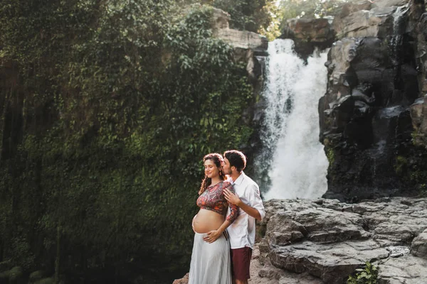 Junges schwangeres verliebtes Paar mit atemberaubender Aussicht auf Tegenungan — Stockfoto
