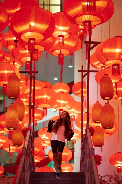 Happy admiring woman enjoying traditional red lanterns decorated — Stock Photo, Image